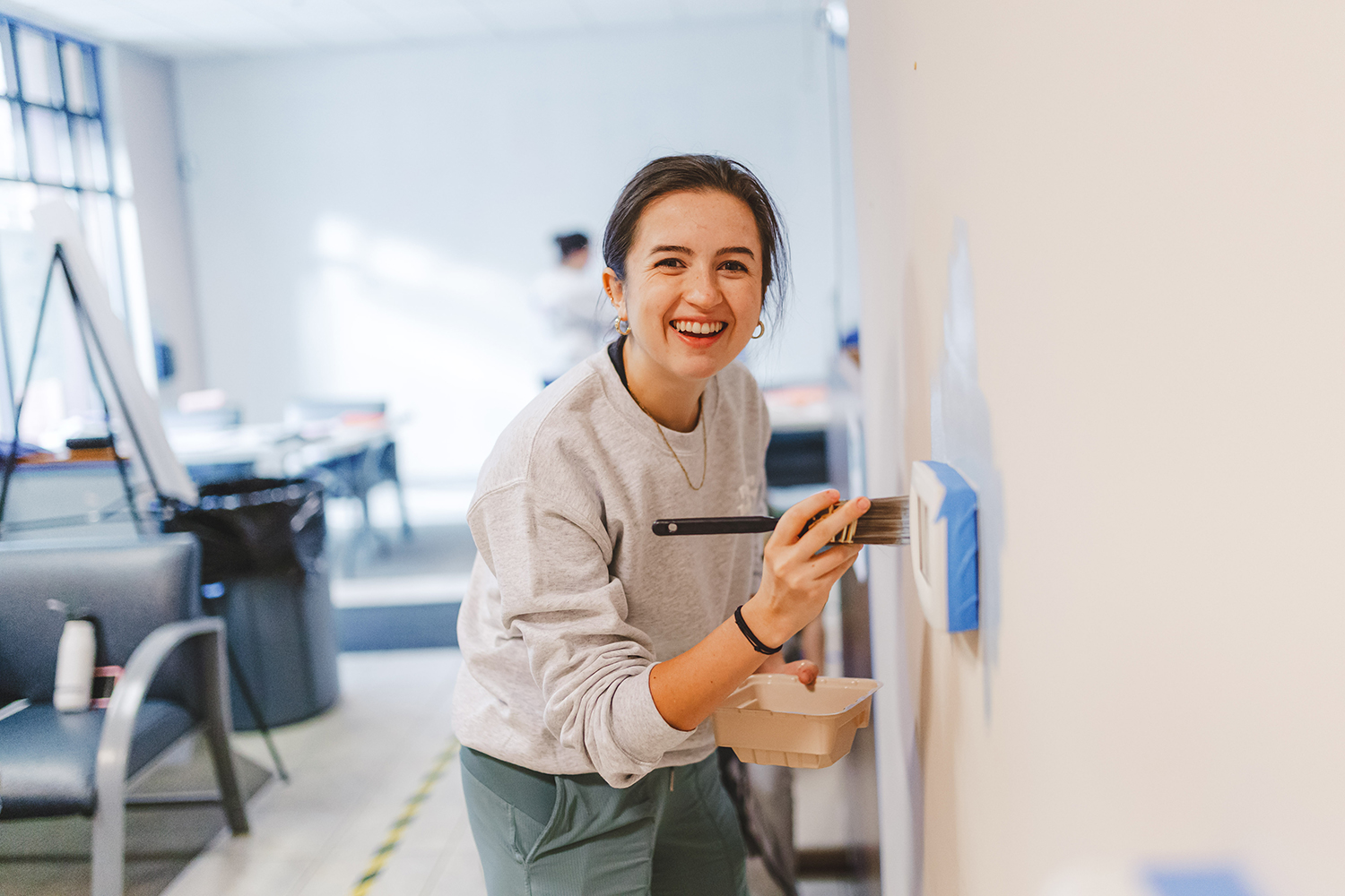 Volunteer paints a Kindering facility