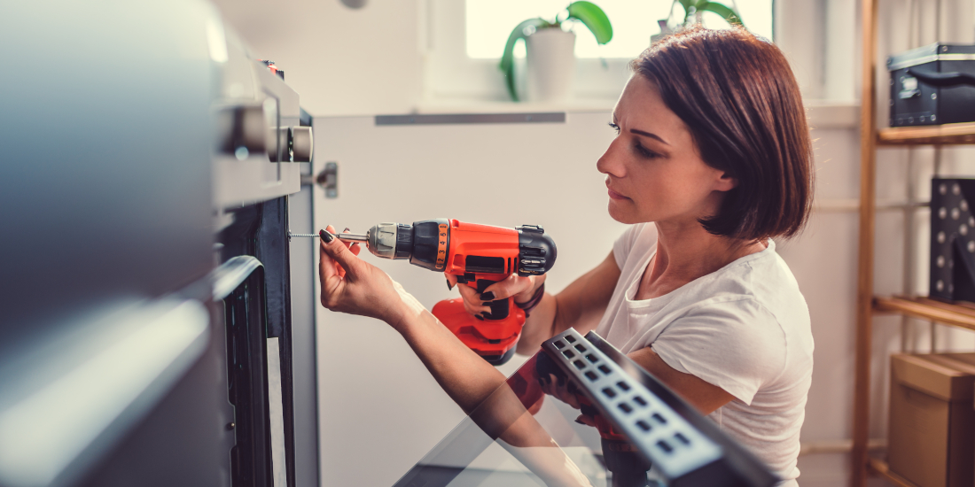 A woman does DIY repair work at home